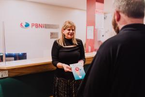 Photo of Gillian Montgomery with Service User and leaflet of Service User forum