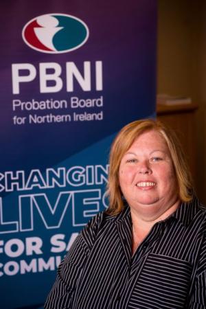 Photo of Pauline Somerville, Head of Information Technology in front of PBNI corporate popup